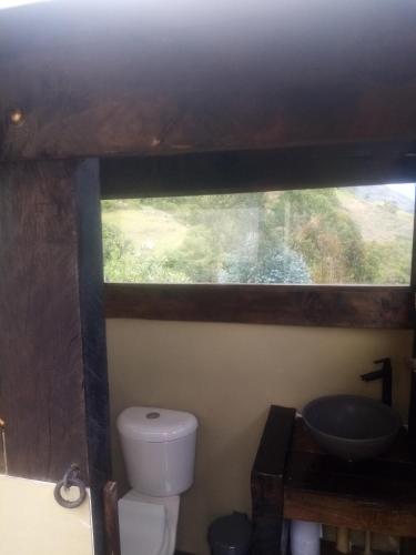 a bathroom with a toilet and a sink at Cabañas M L el cocuy Boyacá in El Cocuy