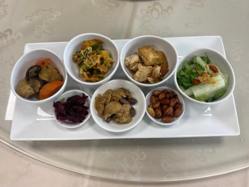 a tray with four bowls of different types of food at Sky Piece B&B in Tamsui
