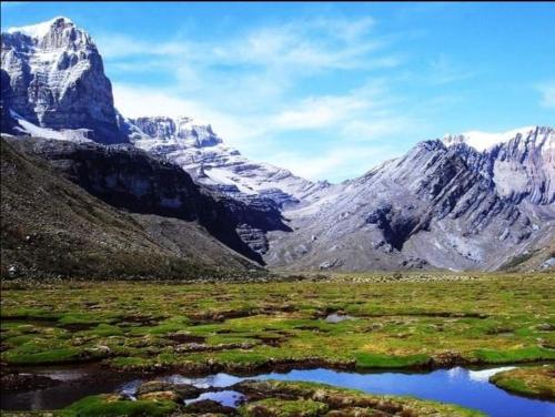 a view of a mountain range with a body of water at Cabañas M L el cocuy Boyacá in El Cocuy