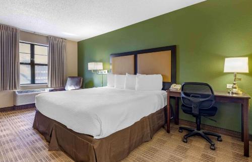 a hotel room with a bed and a desk and a chair at Extended Stay America Suites - Austin - Northwest Arboretum in Austin