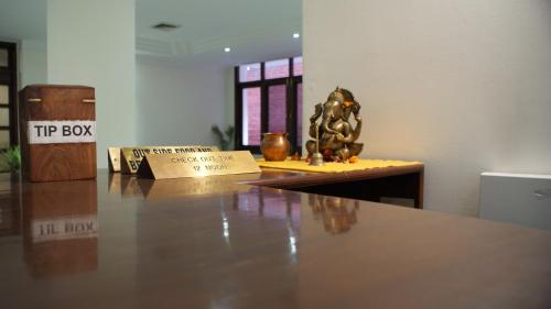 a table with a try box on top of it at Hotel Alpana in Haridwār