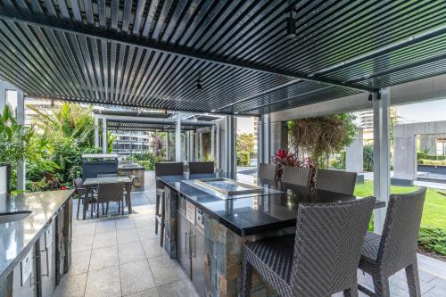an outdoor patio with a table and chairs at Broadbeach Luxury Oracle Tower 1 Apartment 2Bed 2Bath 1 Car in Broadbeach