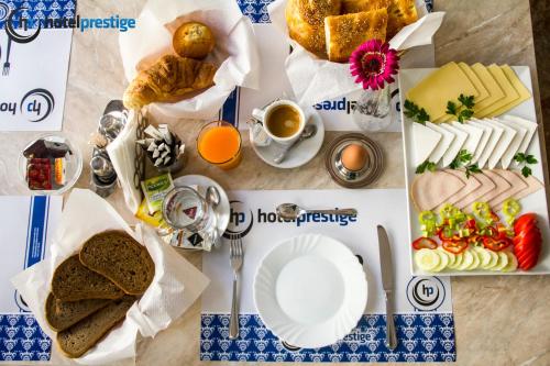 a table with bread and food and a cup of coffee at Hotel Prestige in Brussels