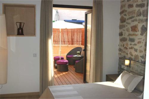 a bedroom with a bed and a view of a room at Petit Hotel C'an Mel in Caʼs Concos