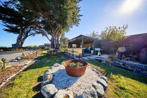 a yard with a potted plant in the grass at The Loft House in Kaikoura