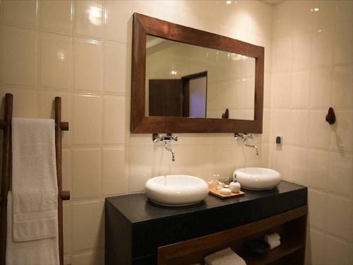 a bathroom with a sink and a mirror at Le Patio in Lomé