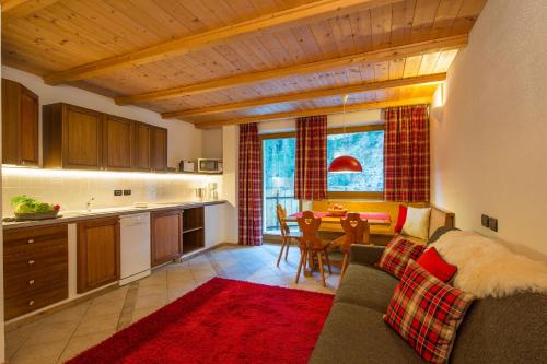 a kitchen and living room with a couch and a table at Stelvio Residence in Trafoi