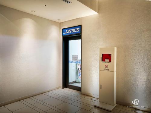a entrance to a library with a sign on the wall at Daiwa Roynet Hotel Yokohama-Koen in Yokohama
