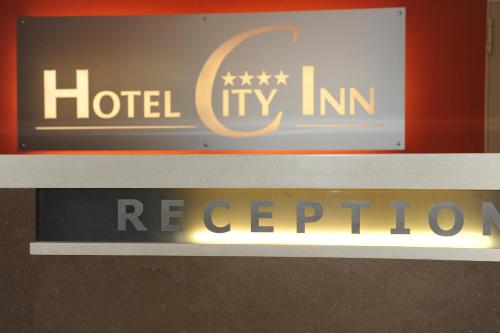 a sign for a hotel tryin reichen abortion at Hotel City Inn in Budapest