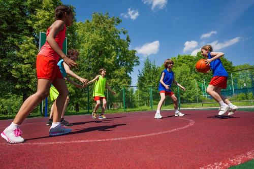 a group of children playing basketball on a court at Lovely 6 Berth Caravan With Decking Nearby Scratby Beach Ref 50017B in Great Yarmouth