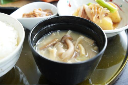 a bowl of soup on a tray with other bowls of food at Chateraise Hotel Nagano in Nagano