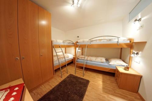 a room with two bunk beds and a closet at Unterbergerhof in Val di Vizze