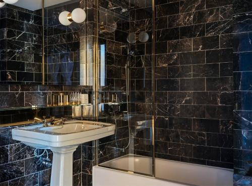 a bathroom with a sink and a shower at The Manner, The Unbound Collection by Hyatt in New York