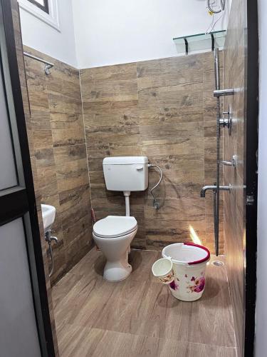 a bathroom with a toilet and a shower at Urban green Studio Apartment in Jorhāt
