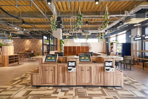 a store with wooden counters in a large room at EIGHT POINT INN Kanazawa in Kanazawa