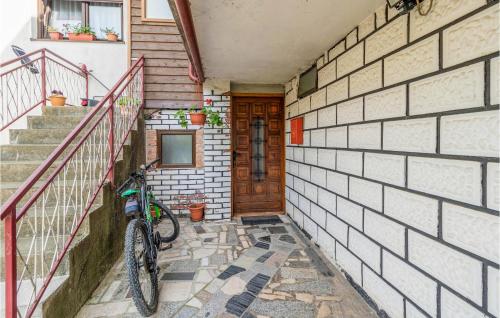 a bike parked in front of a house with stairs at 2 Bedroom Lovely Apartment In Fuzine in Fužine
