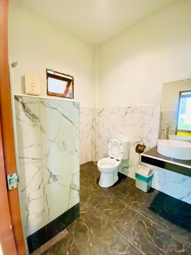 a bathroom with a toilet and a sink at Pranmanee Beach Resort in Sam Roi Yot