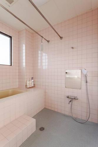 a bathroom with a shower and a tub and a sink at アンドステイ小田原堀之内194 in Odawara