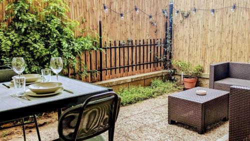 a patio with a table and chairs and a fence at Casa Beatrice in Albinia