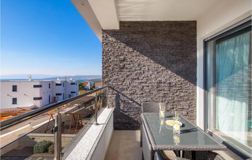 a balcony with a table and a brick wall at Cozy Home In Punat With Sauna in Punat