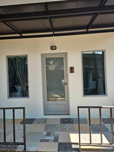 a front door of a house with three windows at Slumberland at Pai in Pai