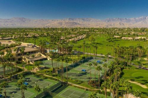 an aerial view of a golf course with palm trees at The Country Club Experience in Palm Desert
