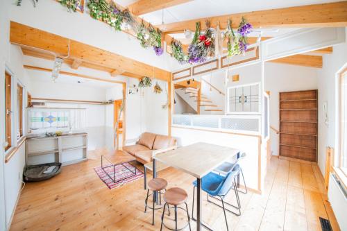a kitchen and dining room with a table and chairs at FamC in Nakafurano