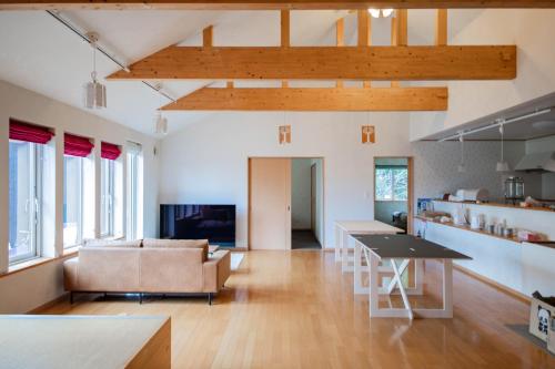 a kitchen and living room with a table and chairs at THE FAM in Nakafurano