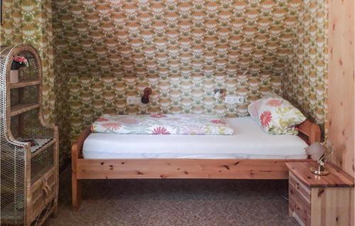 a bed in a room with a wall at Holiday Home Adelshofen Iii in Adelshofen
