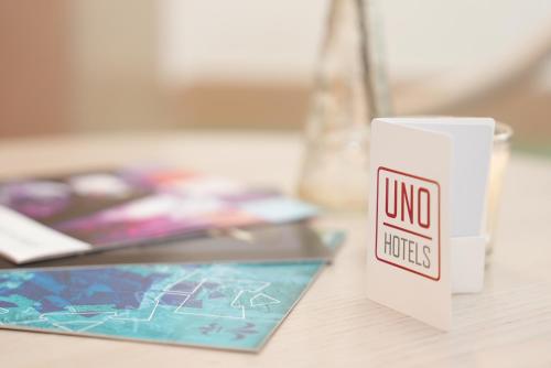 a white cup sitting on a table with a no liquids sign at UNO Hotel Posthof Saarlouis in Saarlouis