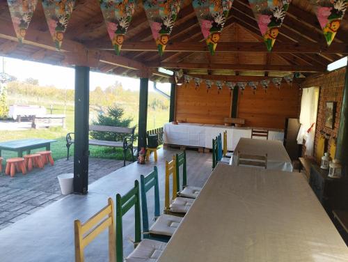 a pavilion with tables and chairs and a bed at Dečiji vinogradi Belgrade, Sopot, Kosmaj in Sopot