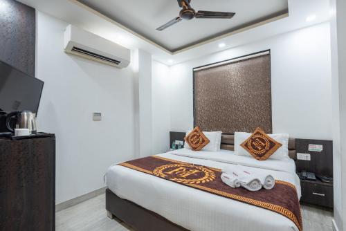 a bedroom with a bed with two toy cars on it at Hotel Royal Inn igi in New Delhi
