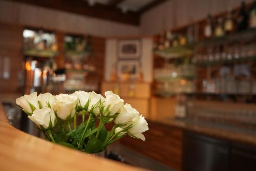 a bouquet of white flowers sitting on a counter in a bar at UNO Hotel Posthof Saarlouis in Saarlouis