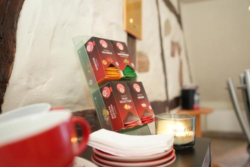 a table with a cup of coffee and a box of donuts at UNO Hotel Posthof Saarlouis in Saarlouis