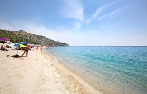 a group of people on a beach with an umbrella at Amazing Home In Staletti With Wifi in Stalettì