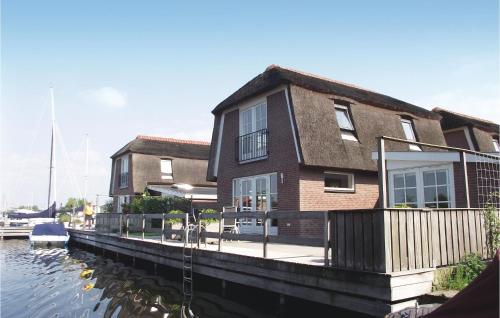 a house on a dock next to a body of water at Holiday Home Breukelen Iv in Breukelen