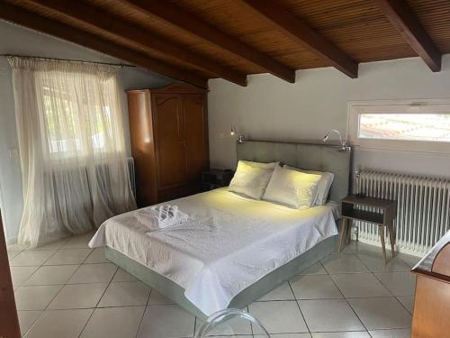 a bedroom with a bed and a table and a window at Attic with a view in Péfka