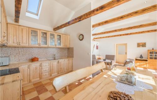 a kitchen with wooden cabinets and a wooden table at Four-Bedroom Holiday Home In Citluk in Čitluk