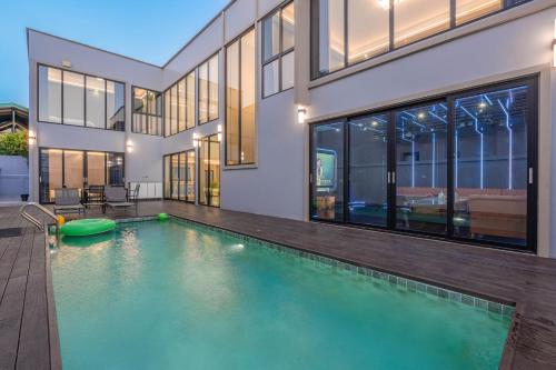 a swimming pool in front of a house at T M L-Jomtien Beach 4 bedrooms - independent swimming pool and KTV in Jomtien Beach