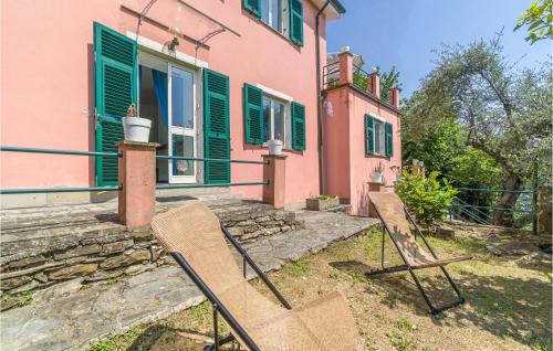 a pair of chairs sitting outside of a house at 3 Bedroom Beautiful Home In Rapallo in Rapallo