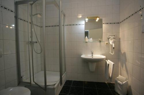a bathroom with a shower and a sink at Stargaze Home Hotel in Haan