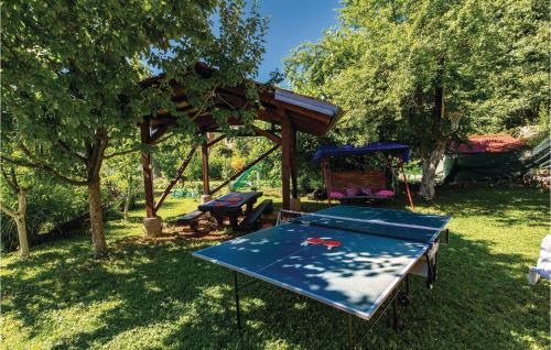 a ping pong table in a yard with a gazebo at 1 Bedroom Pet Friendly Home In Lovran in Lovran