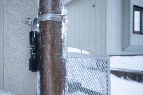 a pole with snow on it next to a fence at DOWNTOWN　TOKO11 in Asahikawa