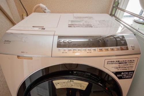 a washing machine with a box on top of it at DOWNTOWN　TOKO11 in Asahikawa