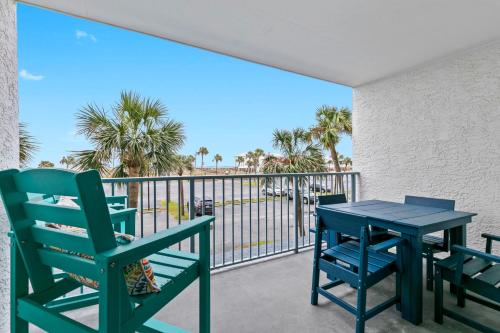 a patio with two chairs and a table on a balcony at Gulf Shores Surf & Racquet Club 212A in Gulf Shores