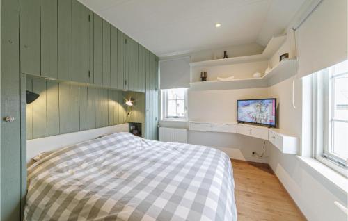 a bedroom with a bed and a tv in it at Amazing Home In Wemeldinge With Wifi in Wemeldinge