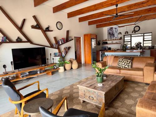a living room with a couch and a table at Mananga Bush Villa in Skukuza
