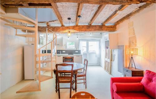 un salon avec une table et un canapé rouge dans l'établissement Amazing Home In Mortagne-Sur-Gironde, à Mortagne-sur-Gironde