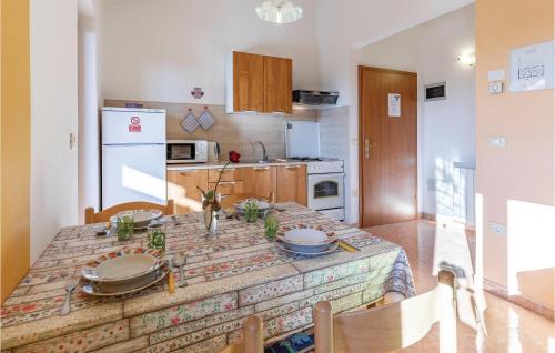 a kitchen with a table with a table cloth on it at One-Bedroom Apartment In Vodnjan in Mednjan