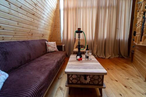 a living room with a couch and a table at Prime House Cottages in Keda